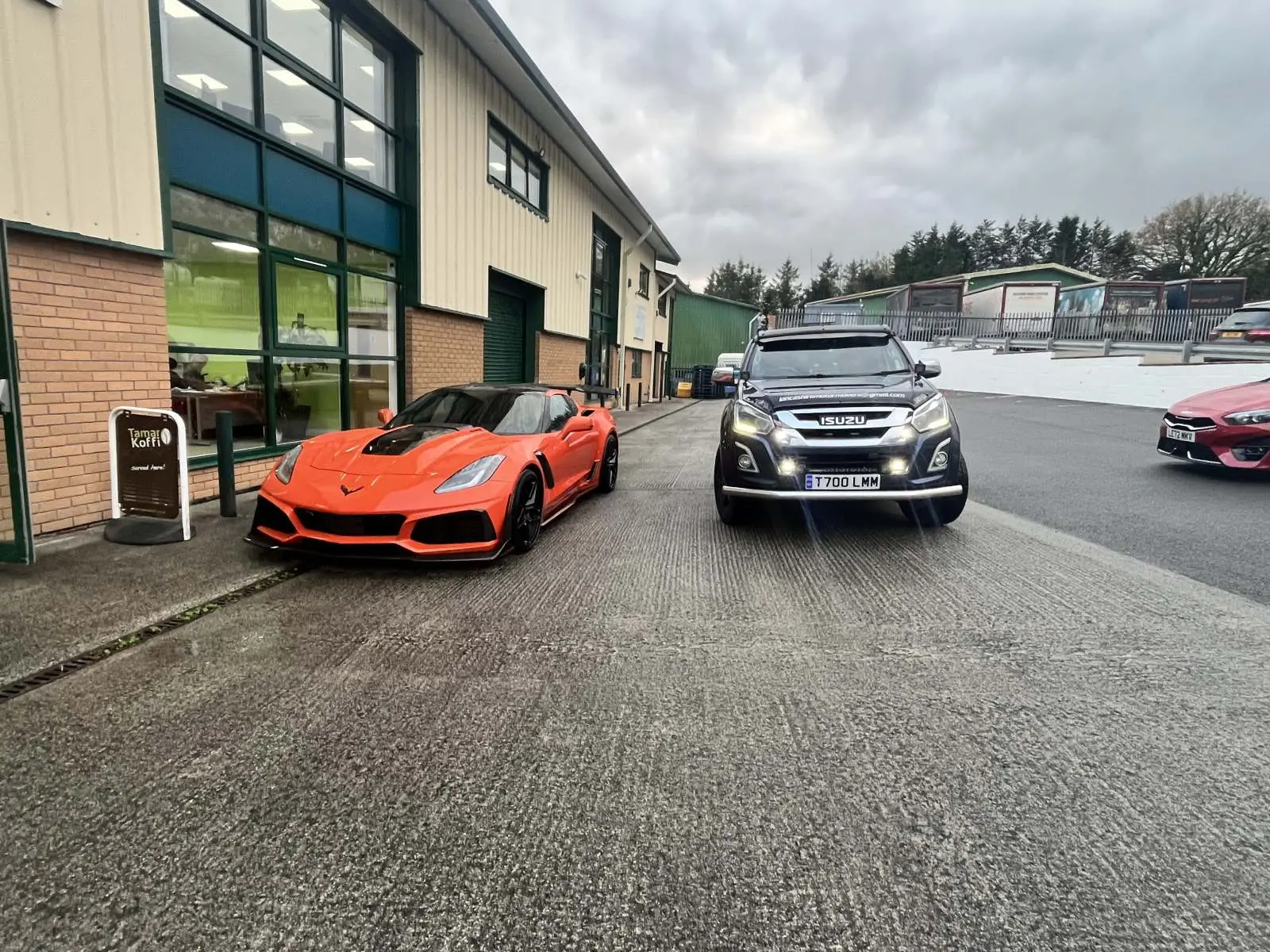 Sports car and saloon collected for delivery outside a dealership Lancashire Motor Movers