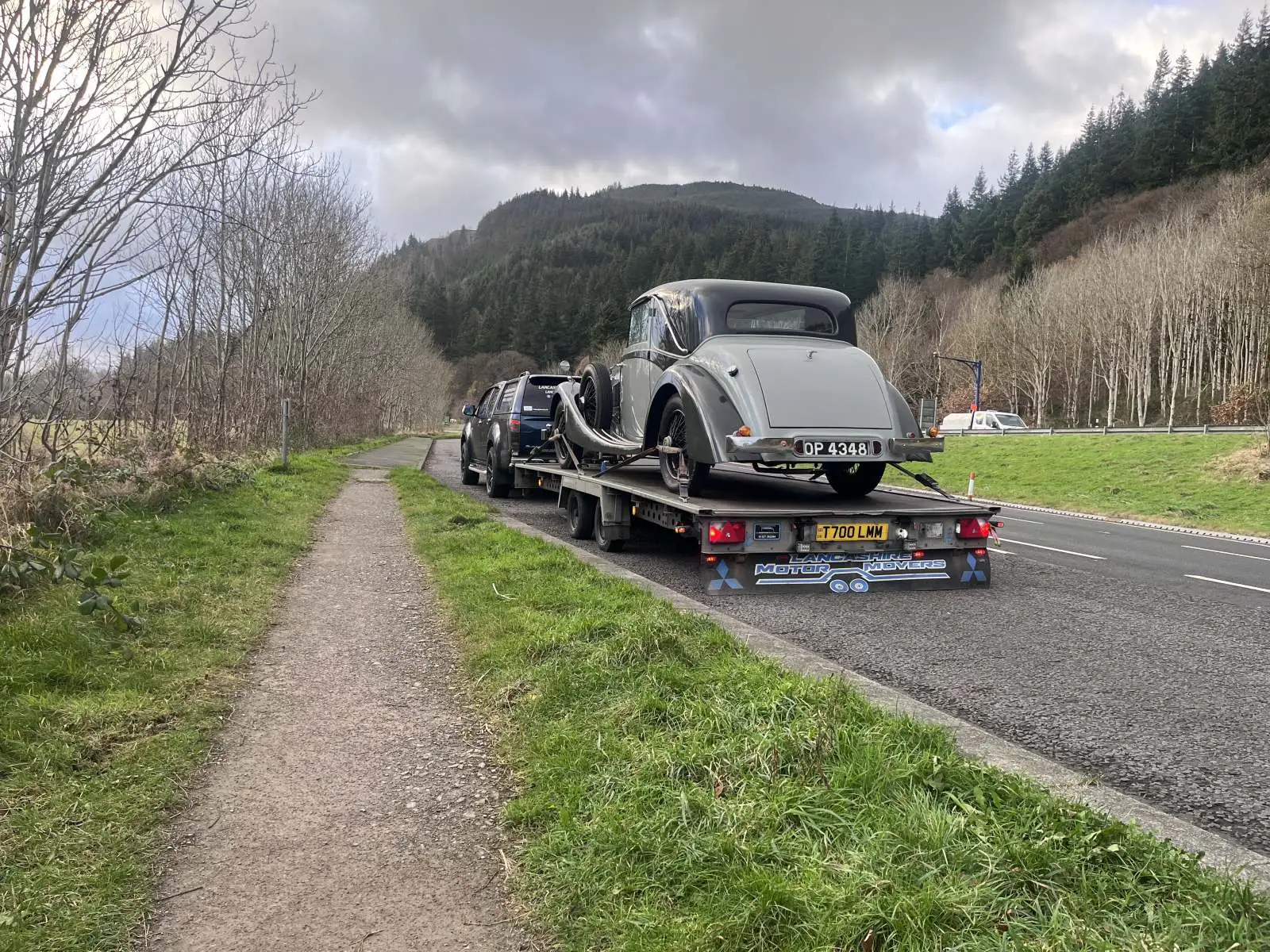 Vehicle loaded on a transporter on a country road Lancashire Motor Movers